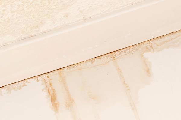 Water damage is visible on an interior ceiling and wall. roofing san marcos