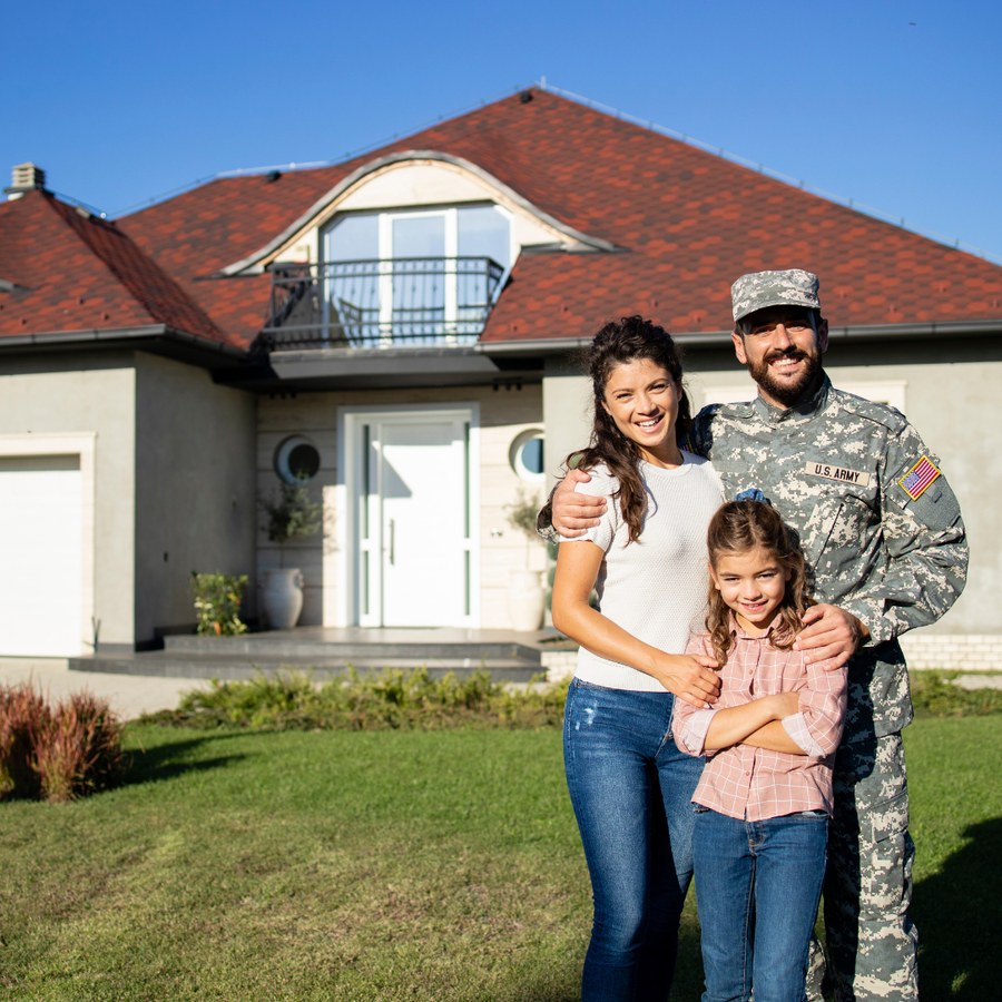 Military family in front of their home