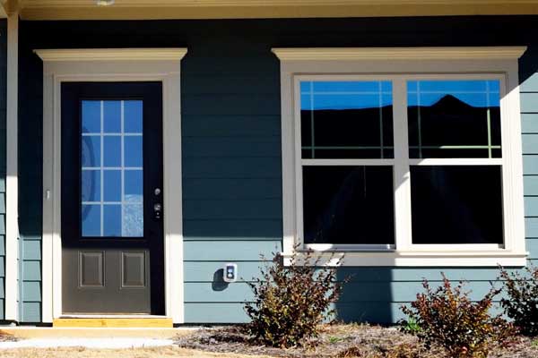 A brand new front door and main window on a home.