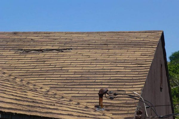 Roof with shingle damage awaiting repairs from our San Marcos roofing team.