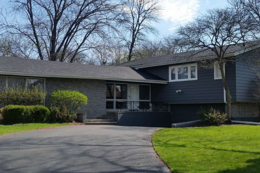 home with asphalt shingle roof installed by Buda roofers