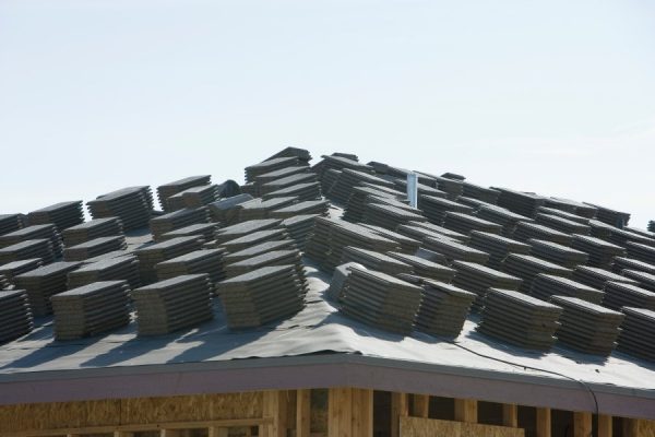 Shingles stacked on a roof by a San Marcos roofing team