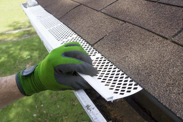 Professional installing commercial and residential gutters in San Marcos