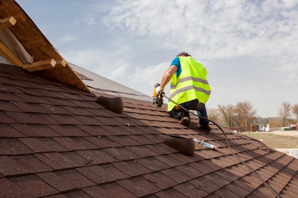 Man installing shingles