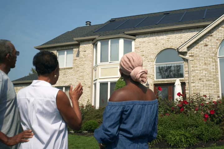 Family celebrating their new solar roof