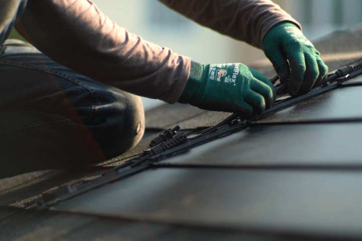 tech installing solar panels