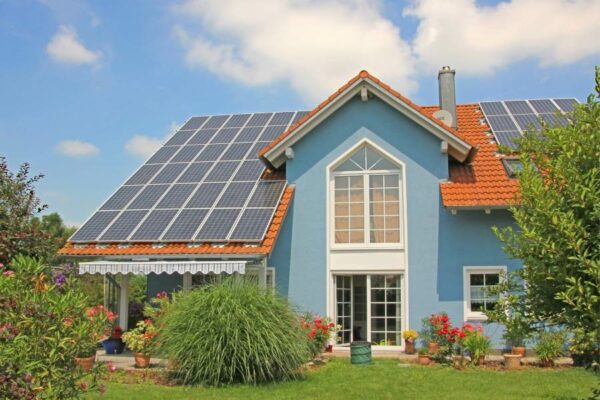 cute blue house with terracotta roof and solar panels