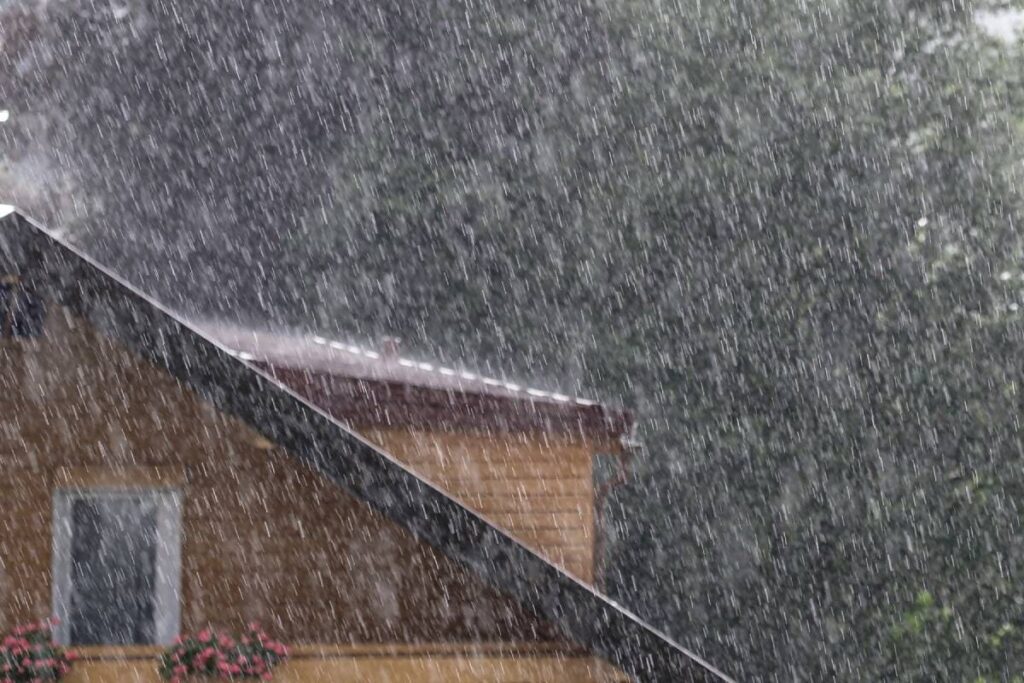 Heavy rain battering a roof protected by Bastrop roofing services.