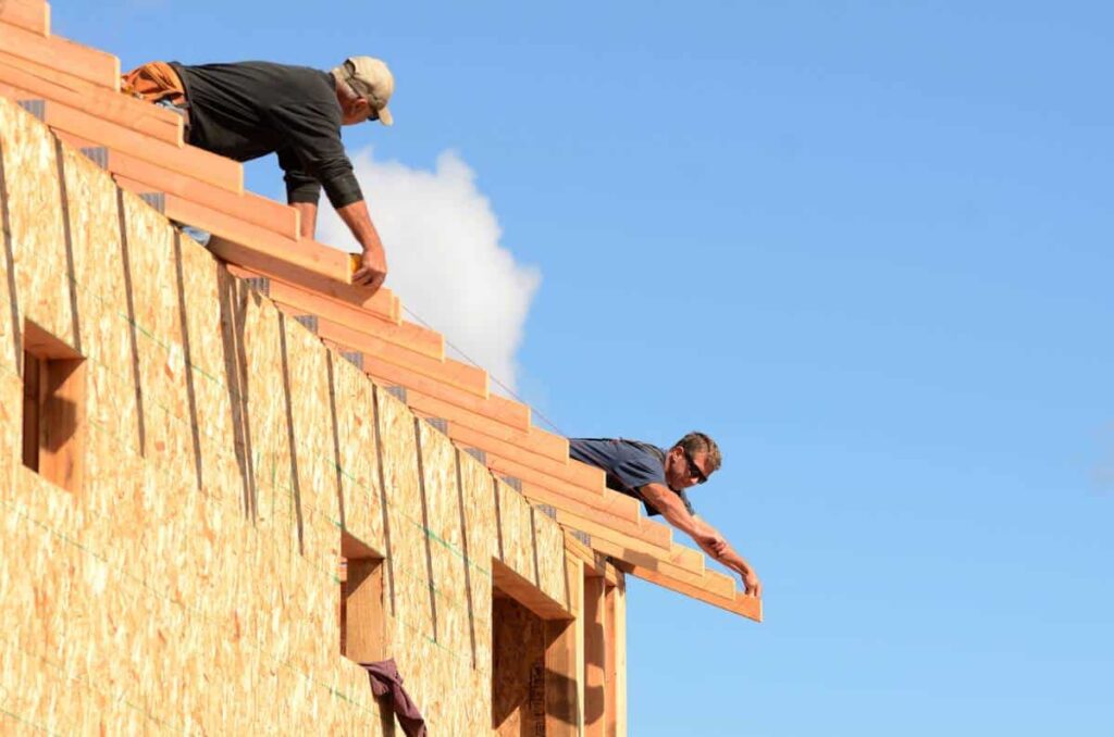 Bastrop roofers working on a home after using roofing squares to provide accurate measurements.