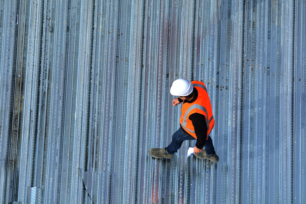 A roofing specialist performing a free roof inspection in Buda.